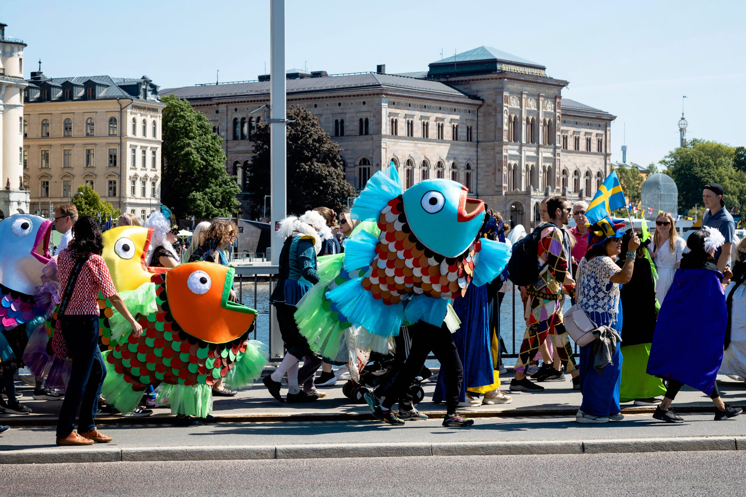 Carneval with fish dolls/dresses on street in Stockholm.