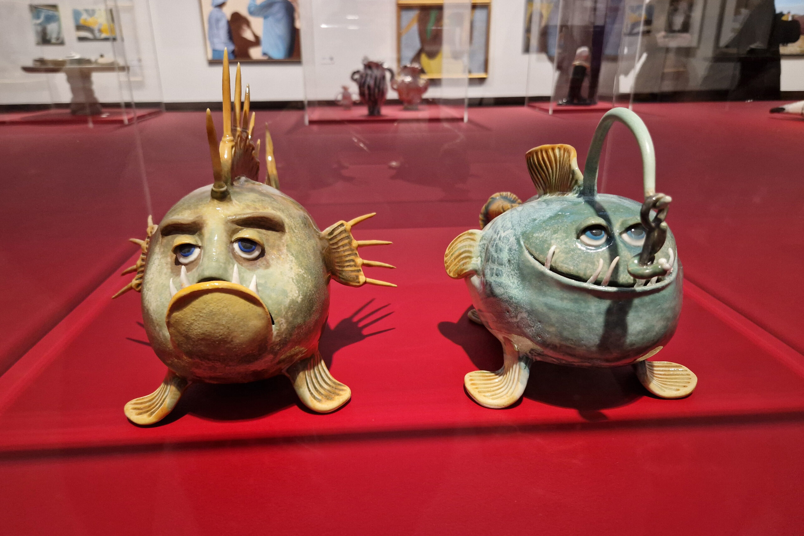 Ceramics art at Liljevalchs. Two humorous models of deep water fishes with cartoonish looking faces.