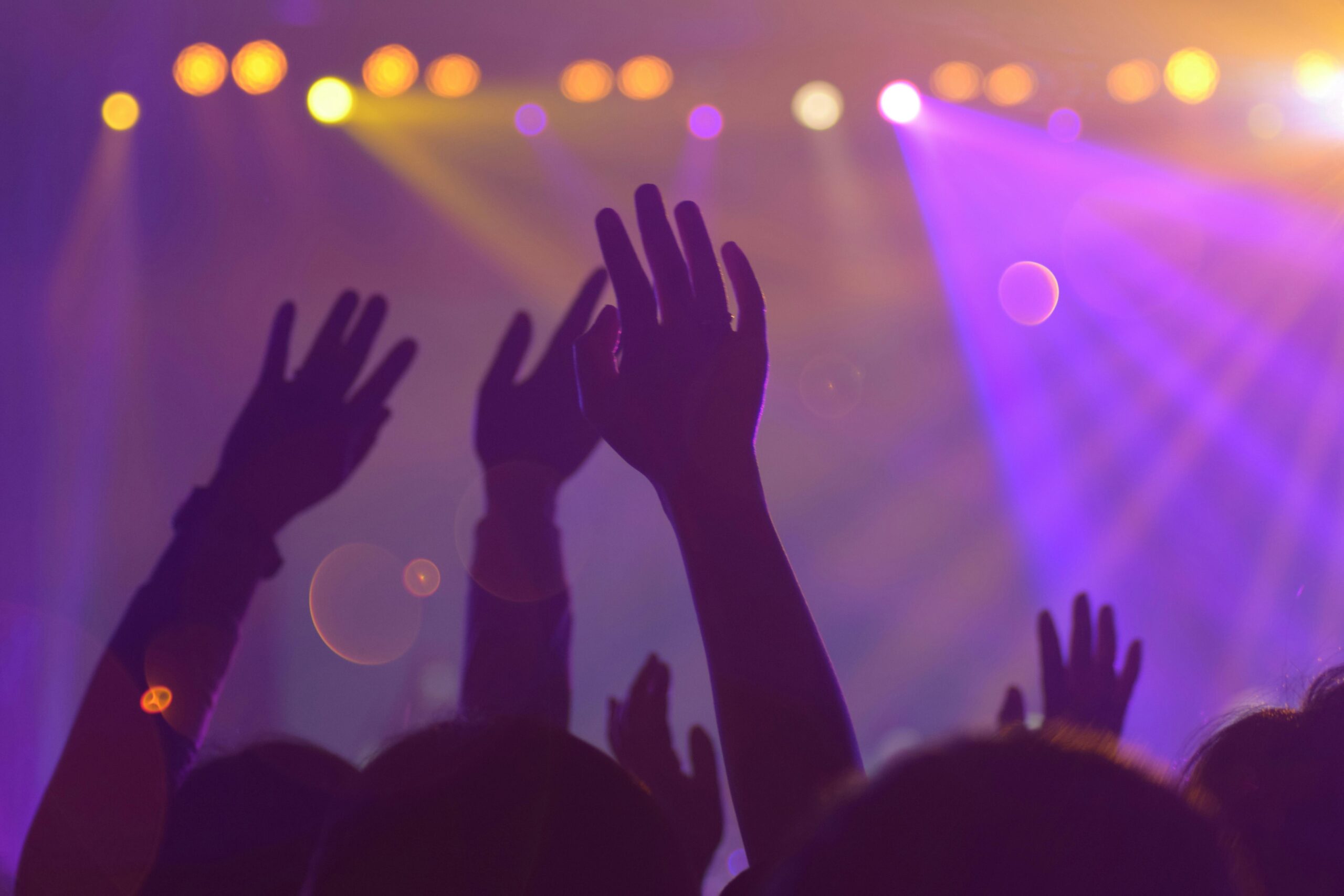 Silhouette of hands at night club