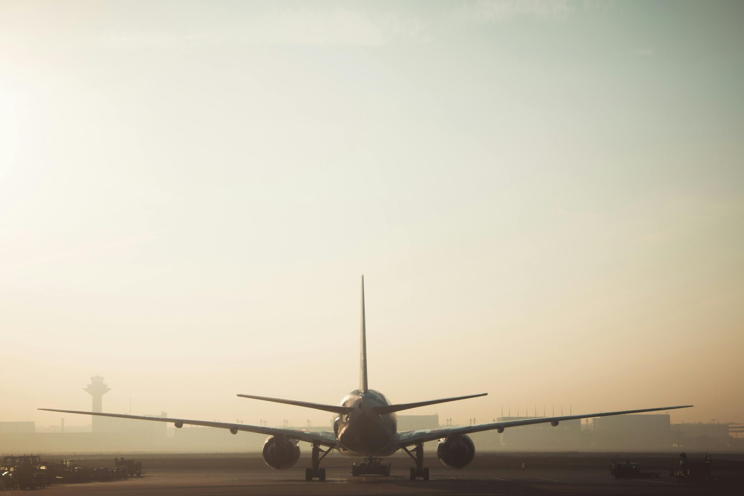 Airplane at airport runway during golden hour