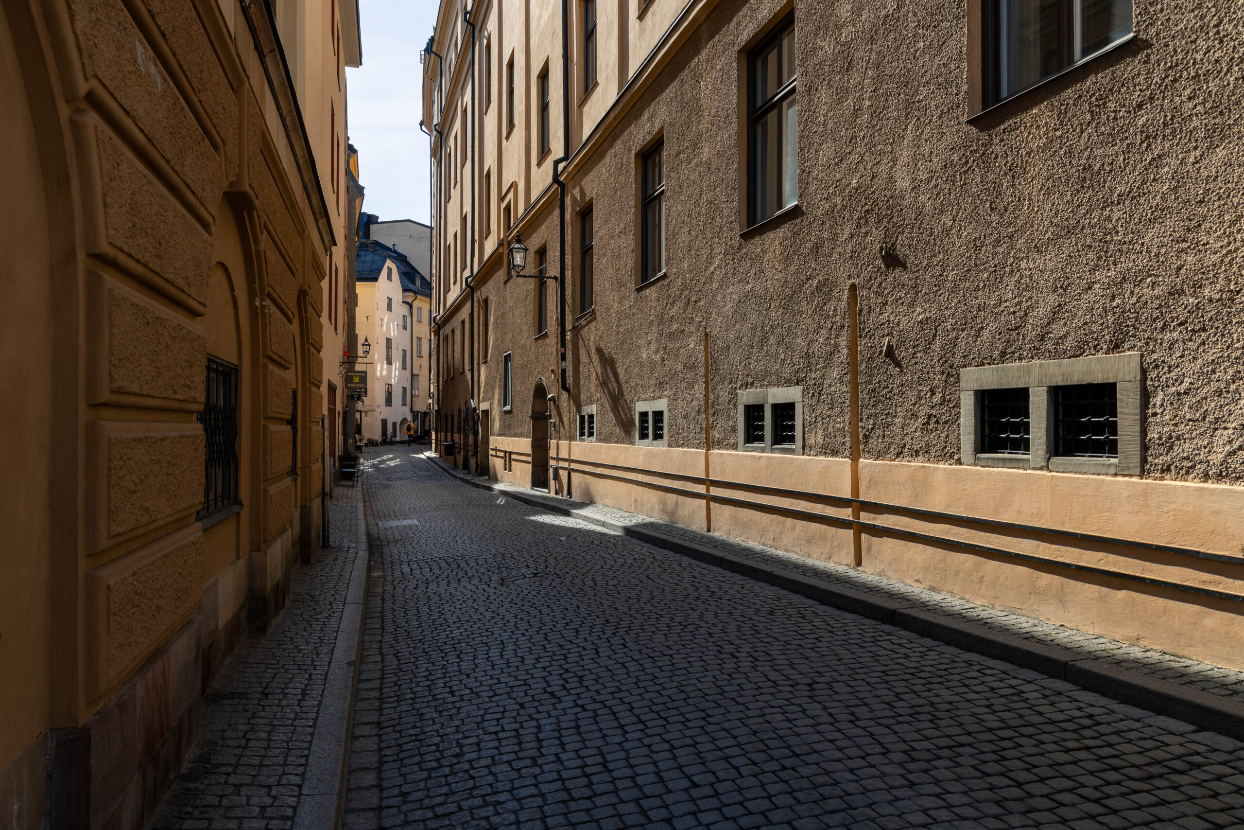 Österlånggatan Street Cobble stone alley (street: Österlånggatan) in Gamla Stan district, in Stockholm Sweden.