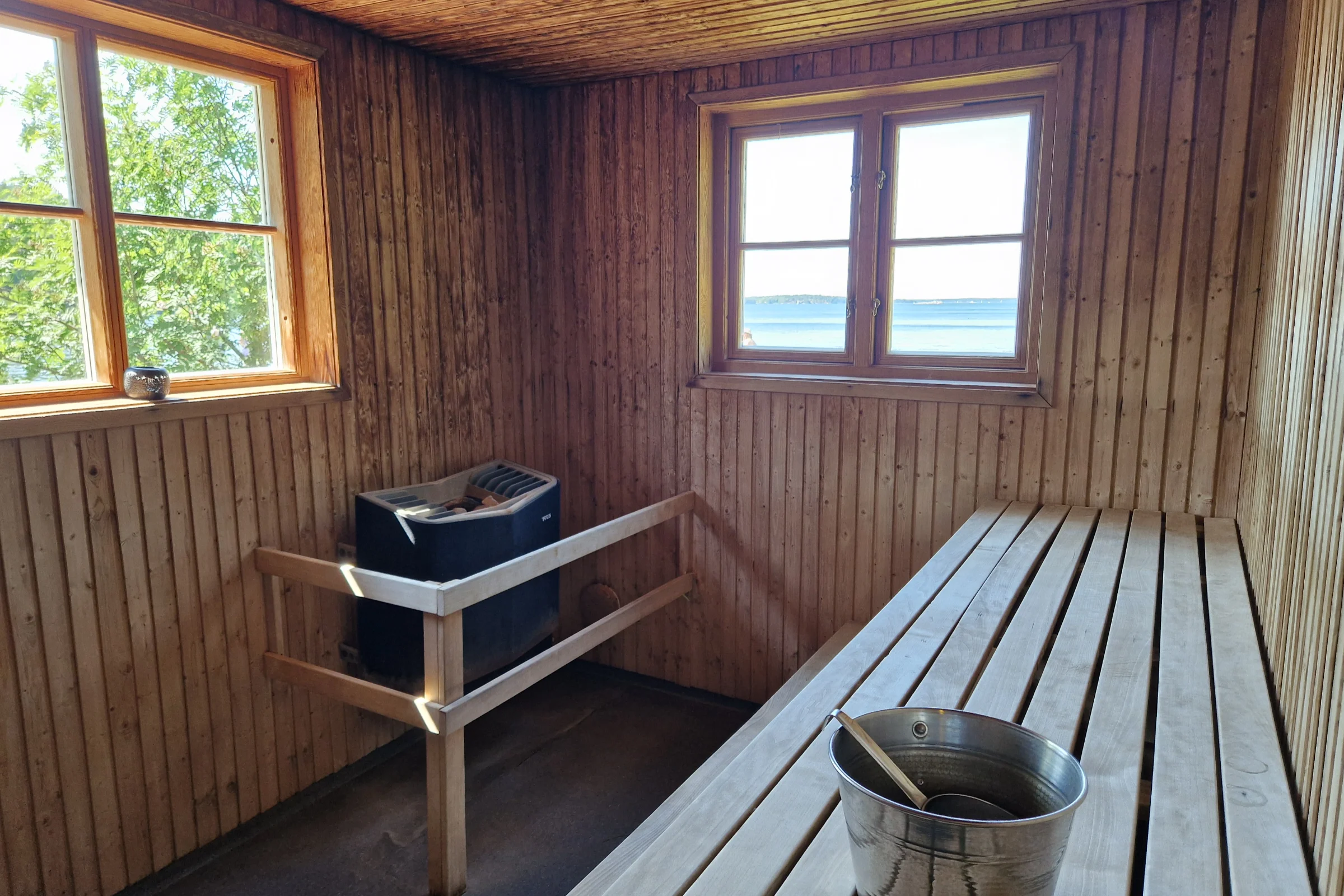Interior of the Grinda sauna with the wooden benches and the electrical heater.