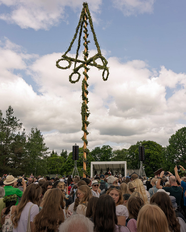 Midsummer at Skansen People around a Maypole (Midsommarstång) at Skansen in Stockholm Sweden.