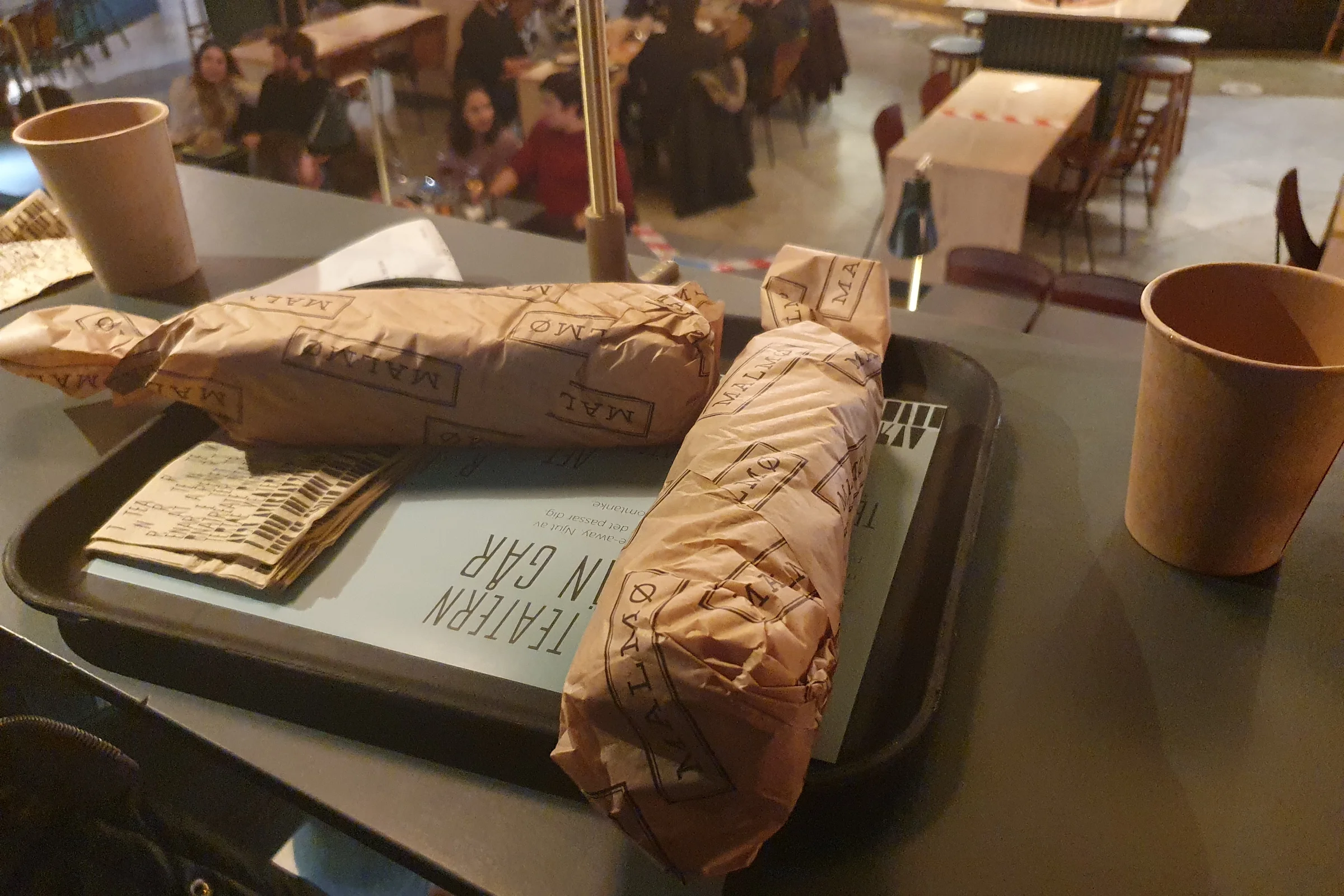 Two wrapped falafels on a table from Malmö Falafel in food court Teatern in Stockholm.