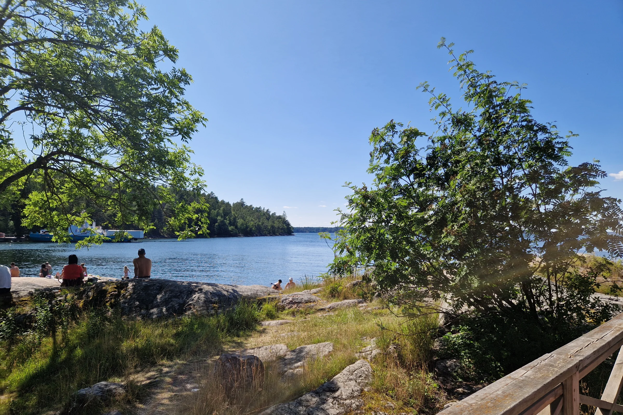 The beach at the Stockholm archipelago island Grinda, with the cliffs where people are sitting sunbathing in the summer.