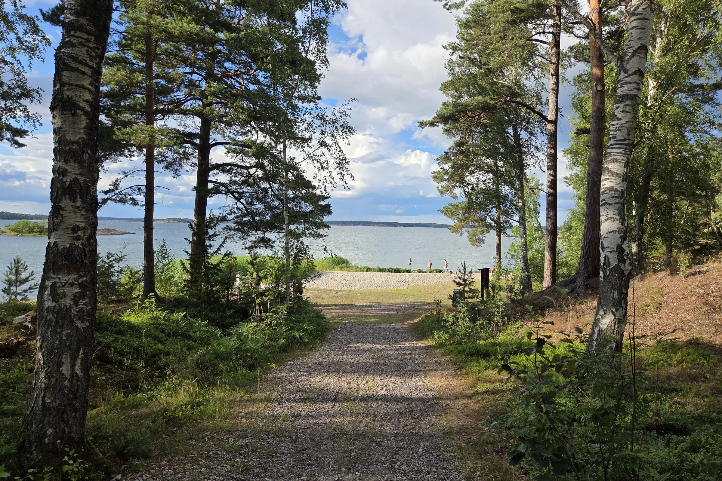 Road leading to a sandy beach at Utö on a sunny summer day.
