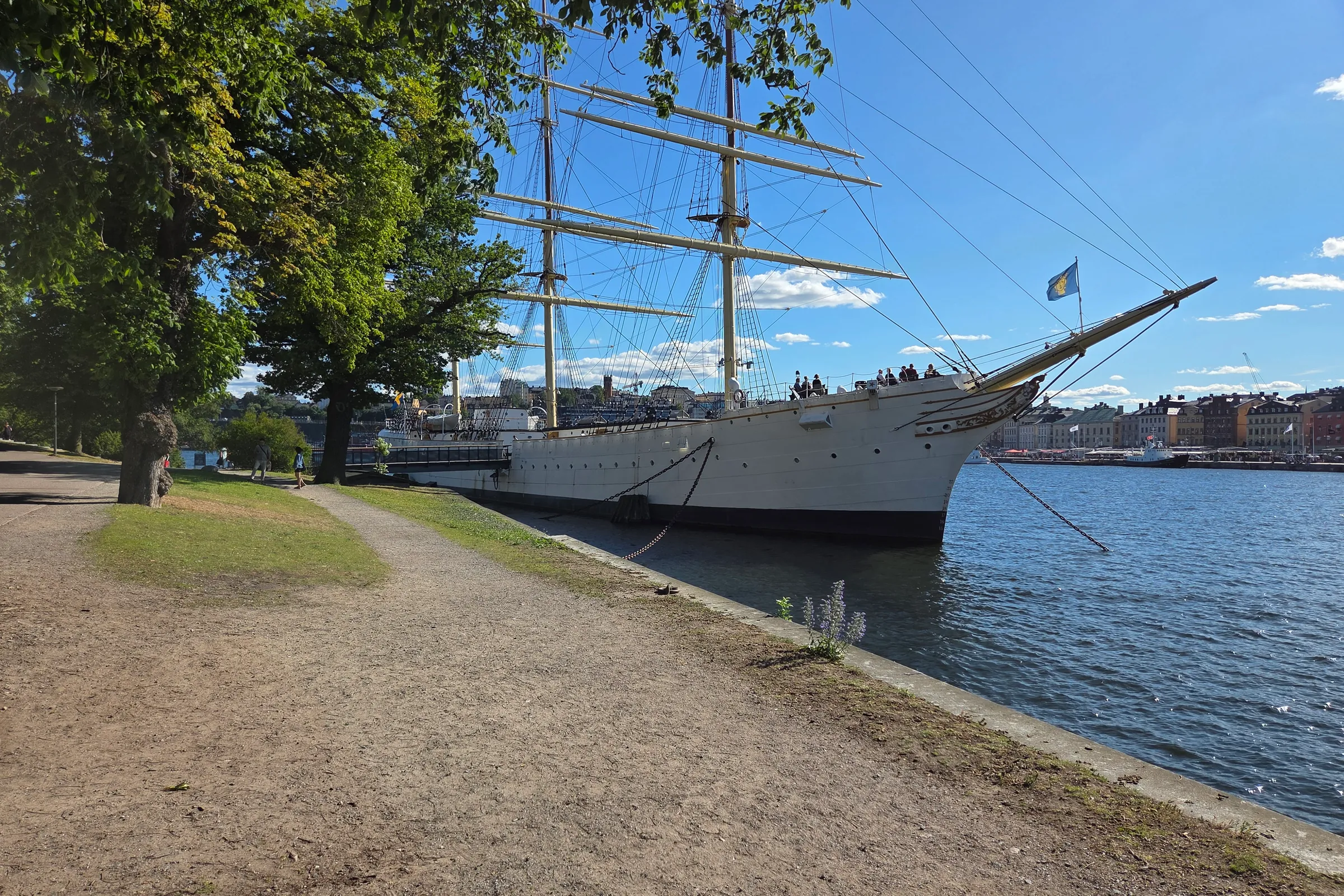 The tall ship af Chapman moored along a waterside path on Skeppsholmen